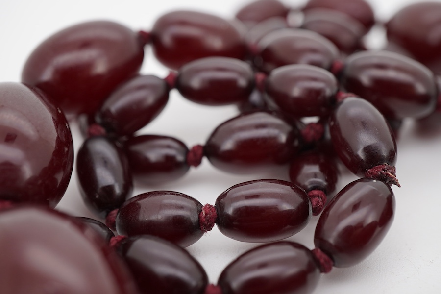 A single strand simulated cherry amber bead necklace, with graduated oval beads, 72cm, gross weight 73 grams.
